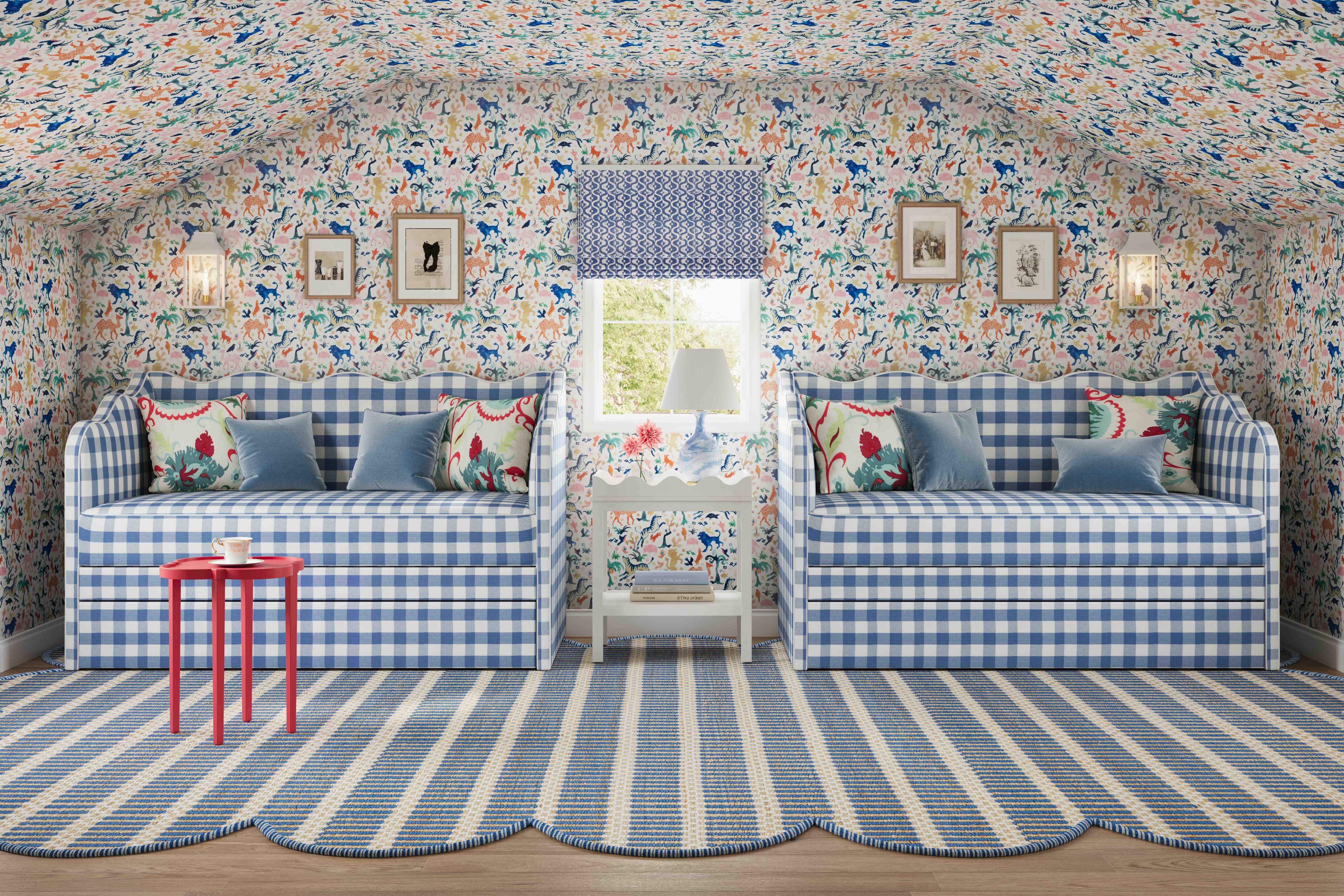 Two blue gingham daybeds with colorful floral wallpaper covering walls and ceiling, and a bold striped rug.