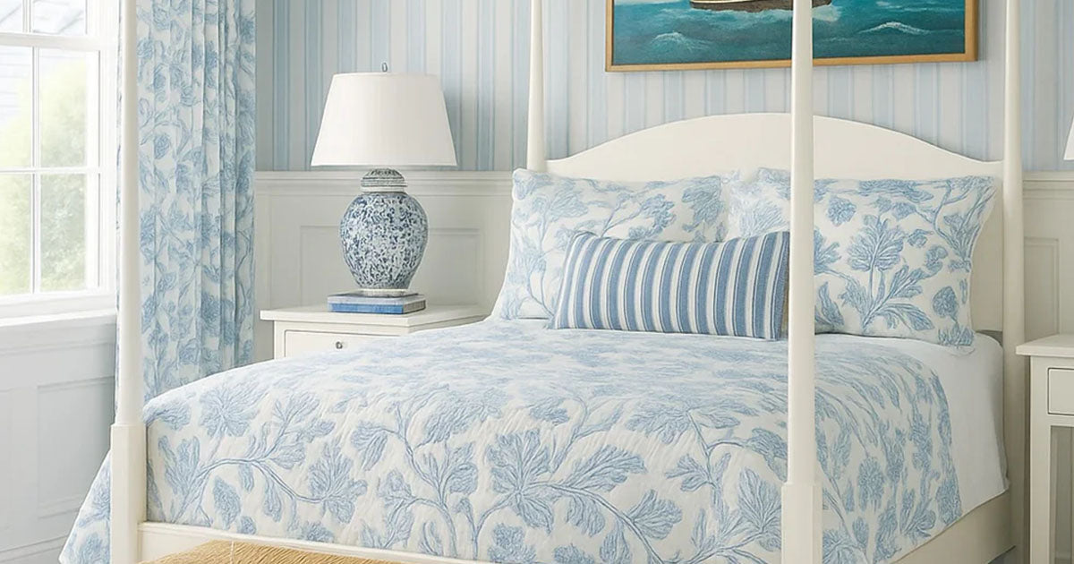 Bespoke white wooden bed frame with blue, flower patterned sheets.