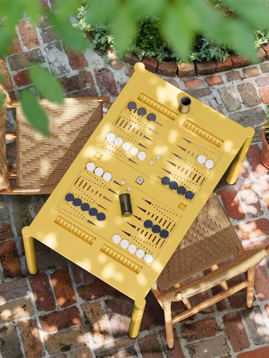 Backgammon 36 in yellow, shown outdoors with game pieces arranged on the tabletop.
