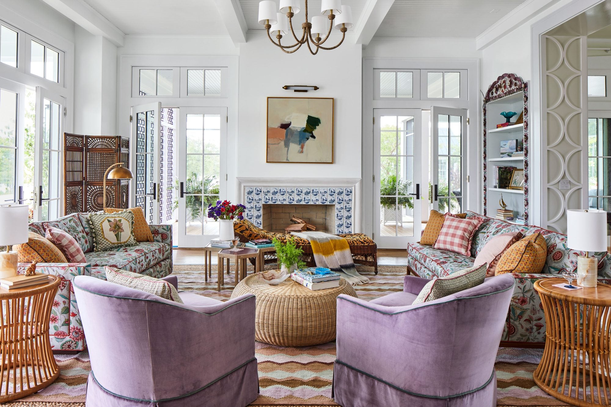 Two purple Madison swivel chairs in front of a large, bright sitting room.