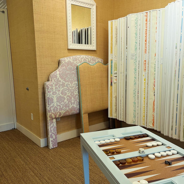 A custom headboard and bespoke backgammon table on display at oomph's Dallas showroom.